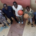 Mangok Bol, an American who resettled in the U.S. decades ago, poses for a photograph with his nieces and nephews, South Sudanese refugees Thon Makech Mach 21, Magot Makech Mach 18, Ajoh Makech Mach 15 and Makuei Makech Mach 11, as he plans to bring them to join him, at their rented apartment in Zimmerman, Kasarani district of Nairobi, Kenya December 15, 2023. REUTERS/Thomas Mukoya