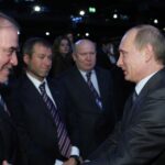 Then-Russian Prime Minister Vladimir Putin, right, congratulates members of the Russian delegation, from left: conductor Valery Gergiyev, businessman Roman Abramovich and Nizhny Novgorod Gov. Valery Shantsev; after it was announced that Russia would host the 2018 soccer World Cup in Zurich, Switzerland, Dec. 2, 2010. When Putin came to power in 2000, the outside world viewed Russia’s “oligarchs” as men who whose vast wealth made them almost shadow rulers. Putin was reported to have told about two dozen of the men regarded as the top oligarchs in a meeting later in 2000 that if they stayed out of politics, their wealth wouldn’t be touched. (AP Photo/Alexei Nikolsky, Pool, File)