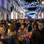eople look up at Christmas lights as crowds stroll around downtown Lisbon’s Chiado neighborhood, Saturday evening, Dec. 23, 2023. (AP Photo/Armando Franca)