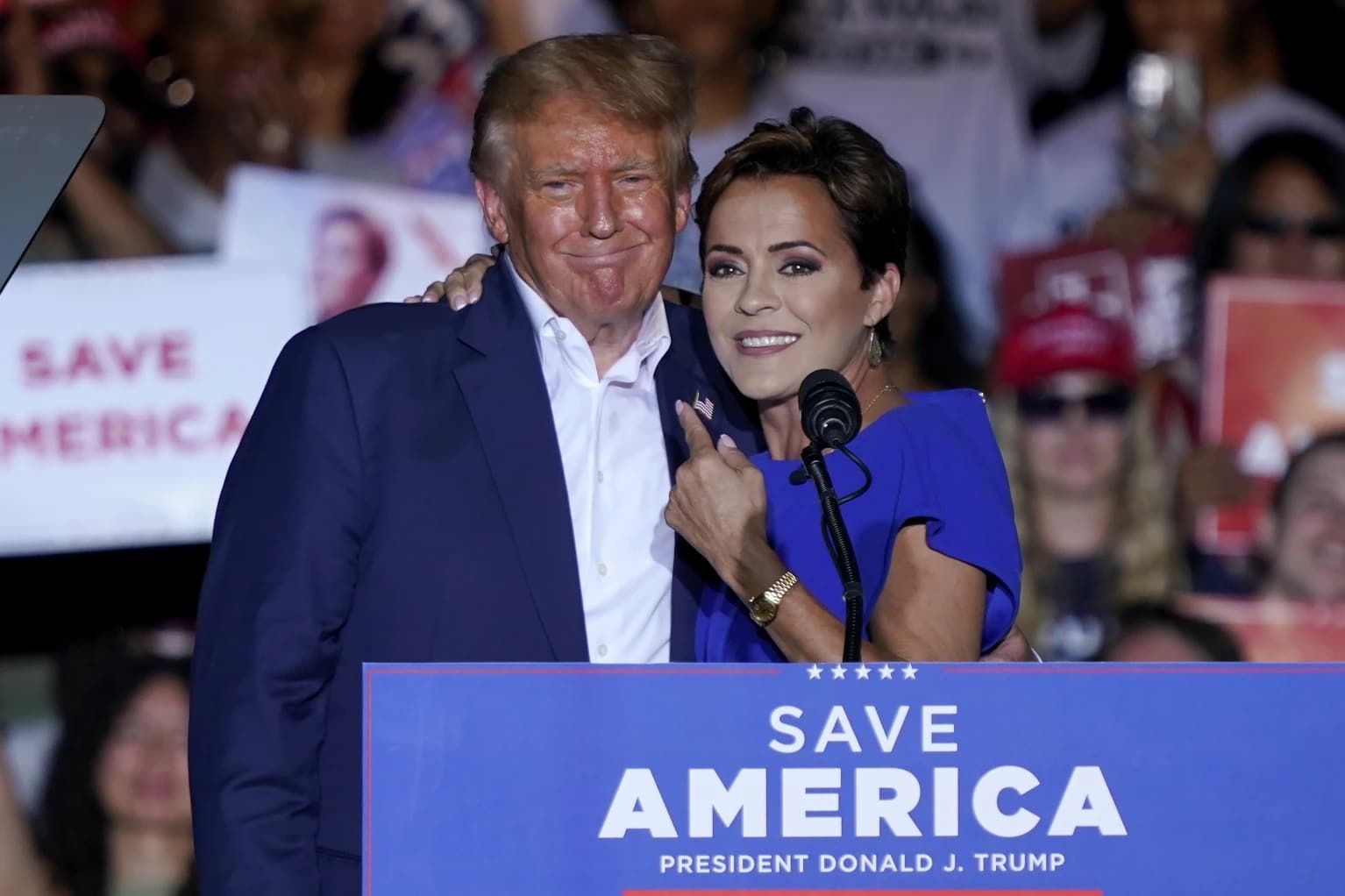 Arizona Republican gubernatorial candidate Kari Lake, right, speaks as former President Donald Trump listens during a rally, Oct. 9, 2022