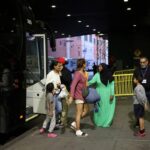 Migrants arriving from Texas by bus disembark at the Port Authority bus terminal in New York City, U.S., May 10, 2023. REUTERS/Andrew Kelly/File Photo
