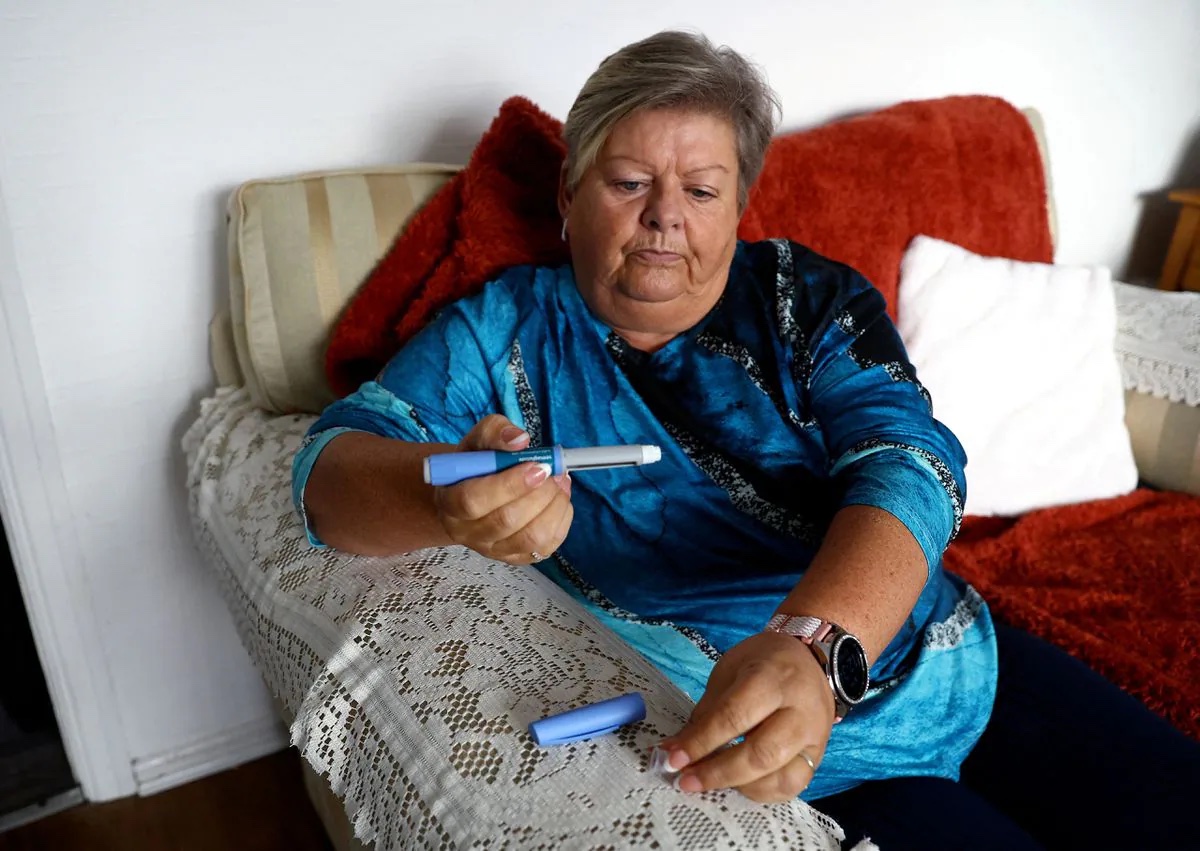 Kim Gradwell begins the Ozempic injection at her home in Dudley, North Tyneside, Britain