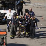 A person is taken to an ambulance after an incident following the Kansas City Chiefs victory parade in Kansas City