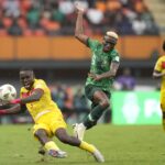 Nigeria’s Victor Osimhen, right, challenges Angola’s Jonathan Buatu during the African Cup of Nations quarterfinal soccer match between Nigeria and Angola, at the Felix Houphouet Boigny stadium in Abidjan, Ivory Coast, Friday, Feb. 2, 2024. 2024. (AP Photo/Sunday Alamba)