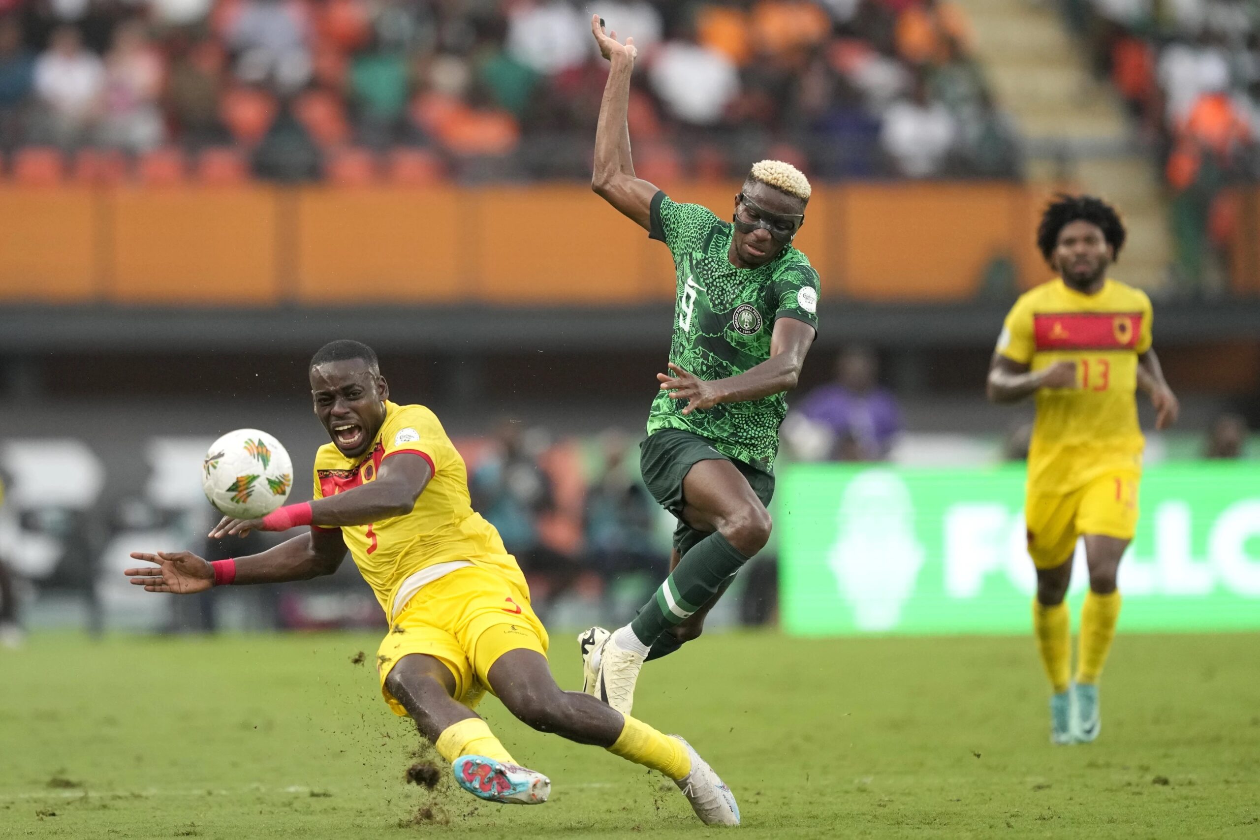 Nigeria’s Victor Osimhen, right, challenges Angola’s Jonathan Buatu during the African Cup of Nations quarterfinal soccer match between Nigeria and Angola, at the Felix Houphouet Boigny stadium in Abidjan, Ivory Coast, Friday, Feb. 2, 2024. 2024. (AP Photo/Sunday Alamba)