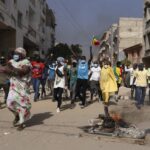 Demonstrators protest President Macky Sall’s decision to postpone the Feb. 25 vote