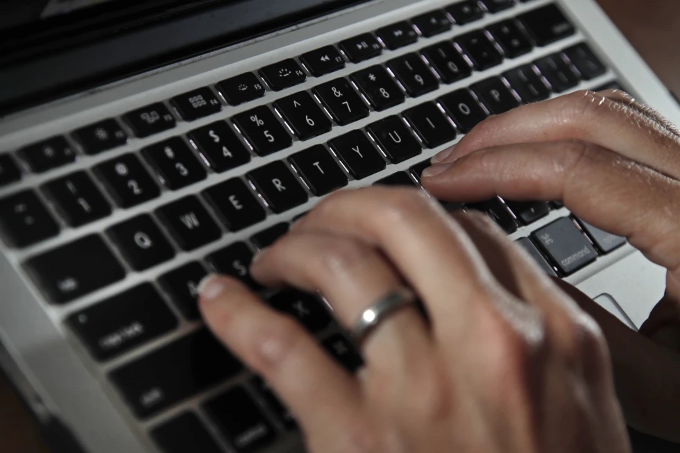 A person works on a laptop