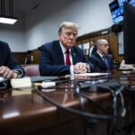 Former President Donald Trump sits in Manhattan criminal court with his legal team in New York