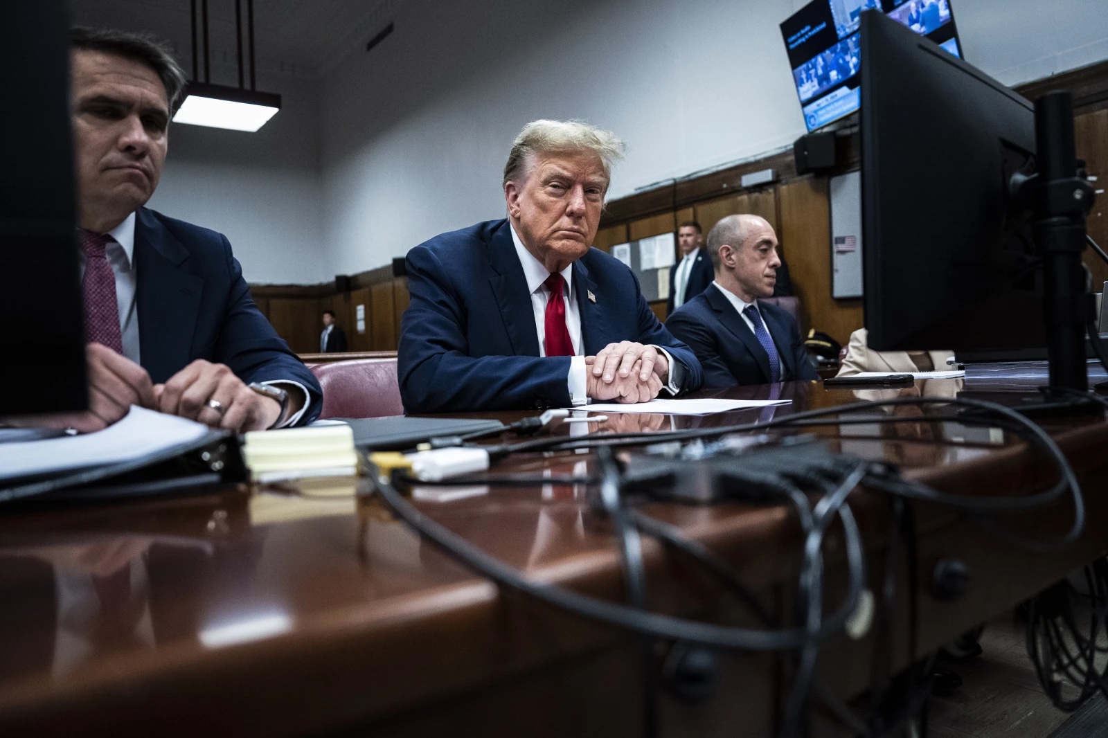 Former President Donald Trump sits in Manhattan criminal court with his legal team in New York