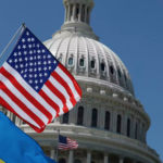 Flags for the United States and Ukraine billow outside of the Capitol building
