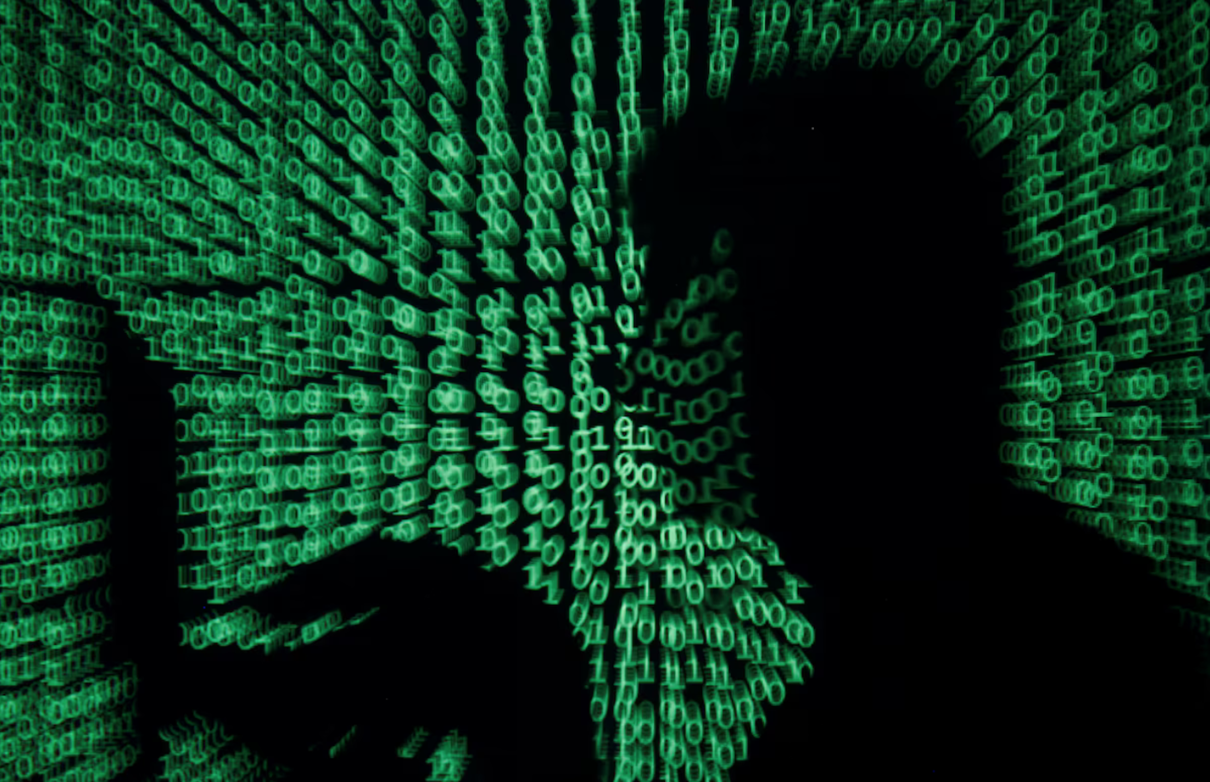 A man holds a laptop computer as cyber code is projected on him in this illustration picture taken on May 13, 2017. REUTERS/Kacper Pempel/Illustration/File Photo