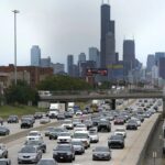 Motorists head southbound in the local and express lanes on Interstates 90-94 in slow and thickening traffic