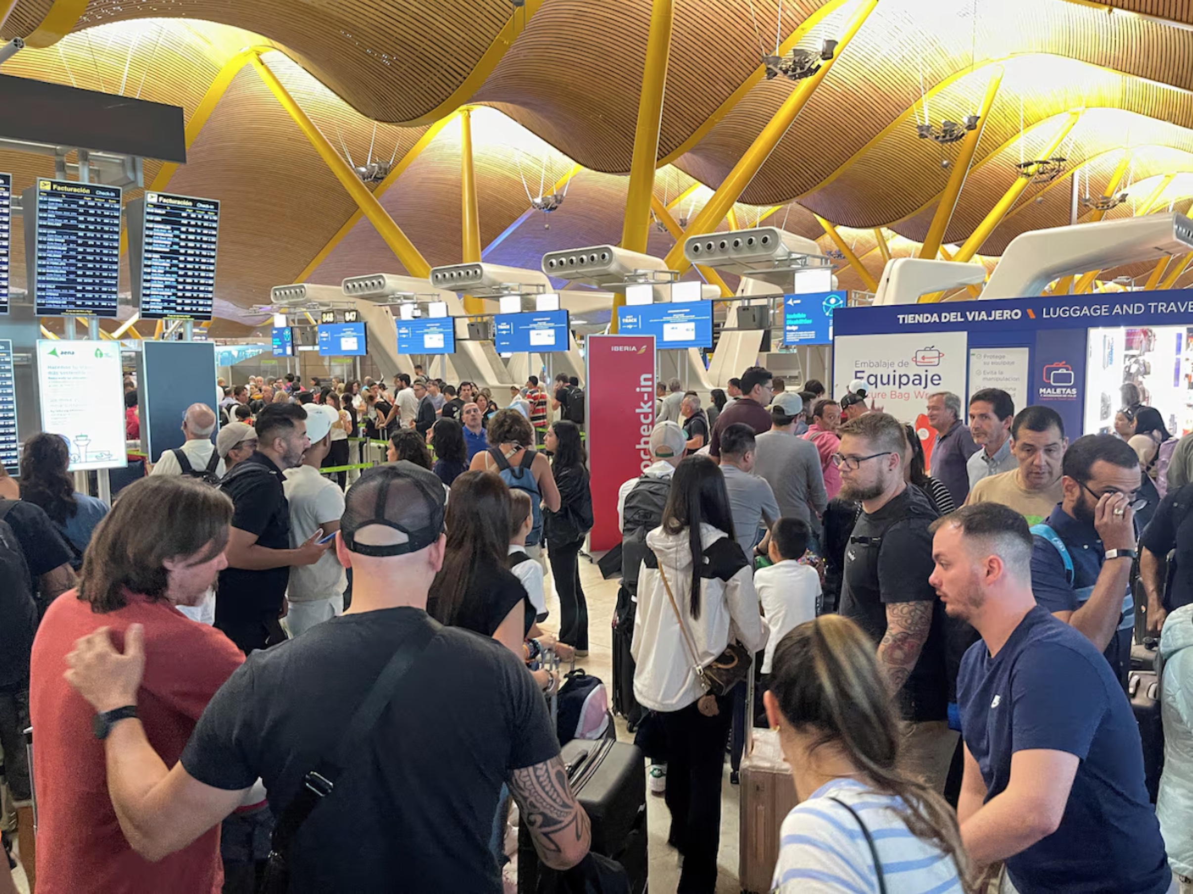 Passengers wait at Barajas Airport, as Spanish airport operator Aena on Friday reported a computer systems "incident" at all Spanish airports which may cause flight delays, in Madrid, Spain July 19, 2024.