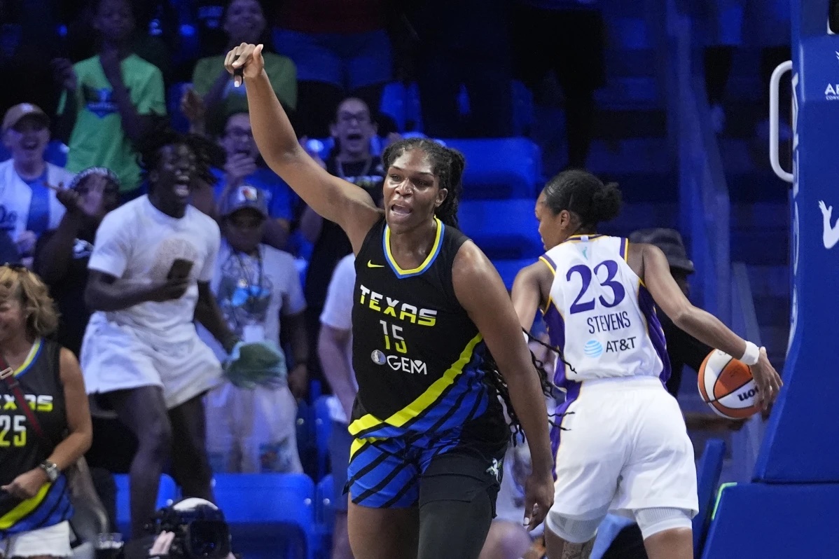 Dallas Wings center Teaira McCowan (15) reacts after scoring the go ahead basket against Los Angeles Sparks forward Azura Stevens (23) during the fourth quarter of a WNBA basketball game in Arlington, Texas, Sunday, Aug. 25, 2024