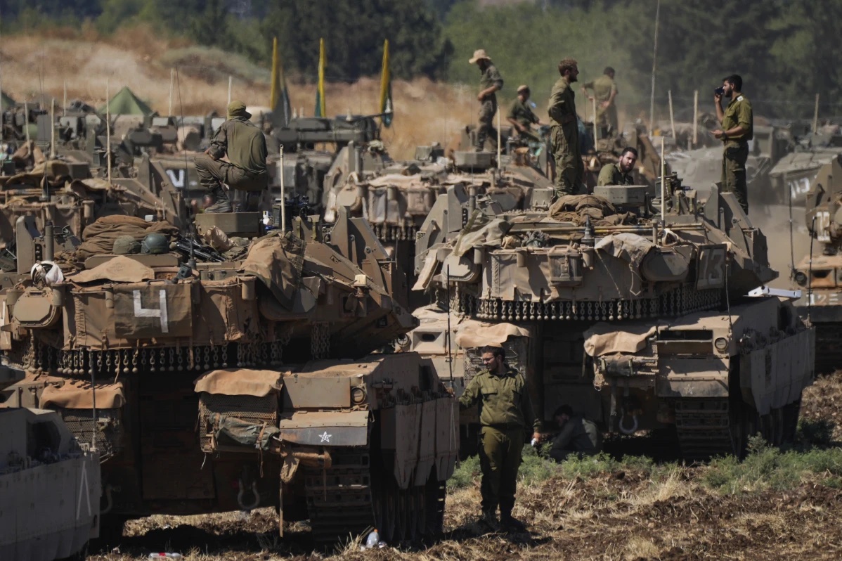 Israeli soldiers work on tanks in northern Israel on Friday, Sept. 27, 2024.