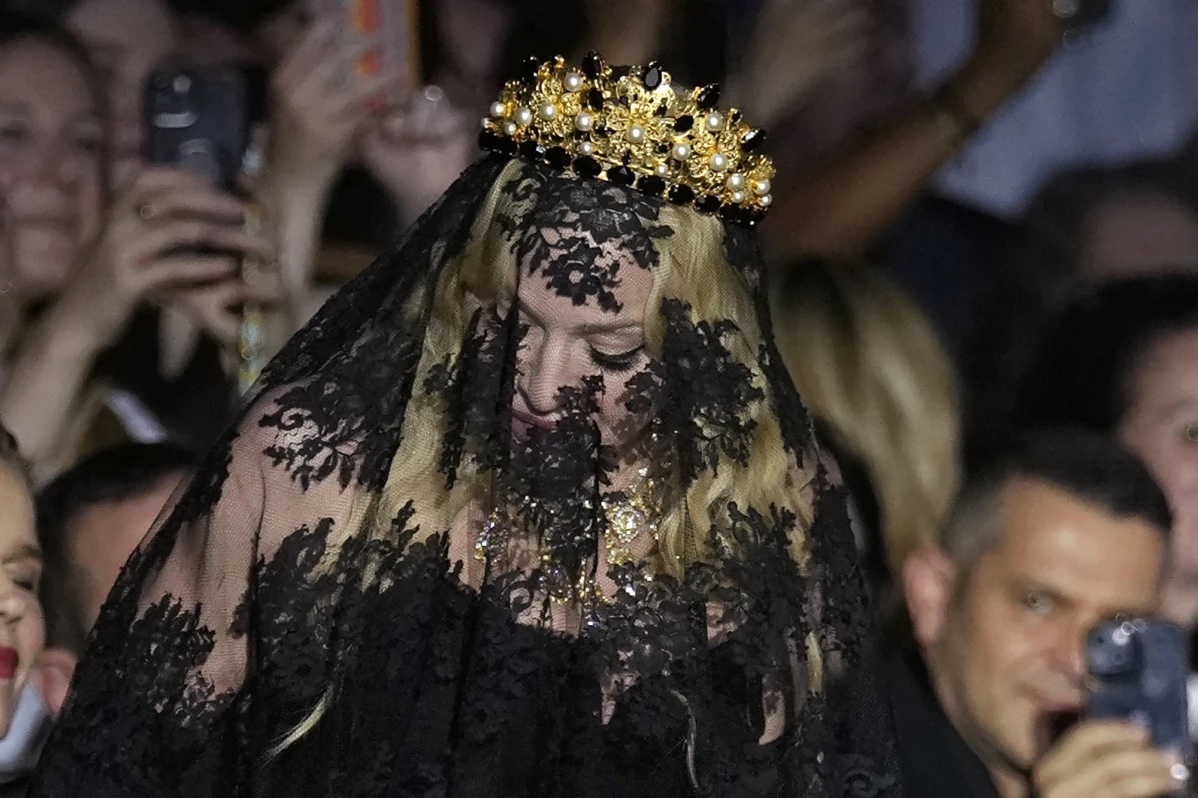 Madonna stands at the end of the Dolce & Gabbana Spring Summer 2025 fashion show, that was presented in Milan, Italy, Saturday, Sept. 21, 2024.