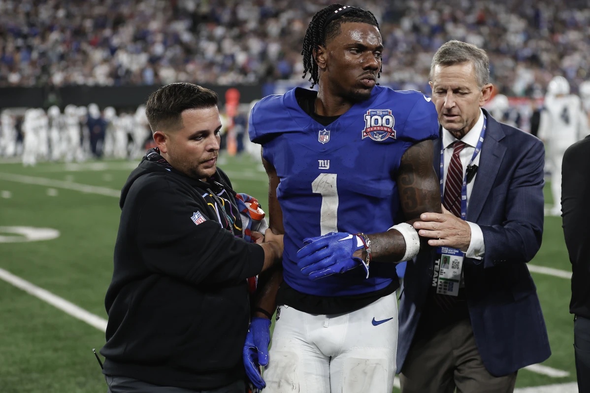 New York Giants wide receiver Malik Nabers (1) is helped off the field after an injury during the fourth quarter of an NFL football game against the Dallas Cowboys, Thursday, Sept. 26, 2024, in East Rutherford, N.J.