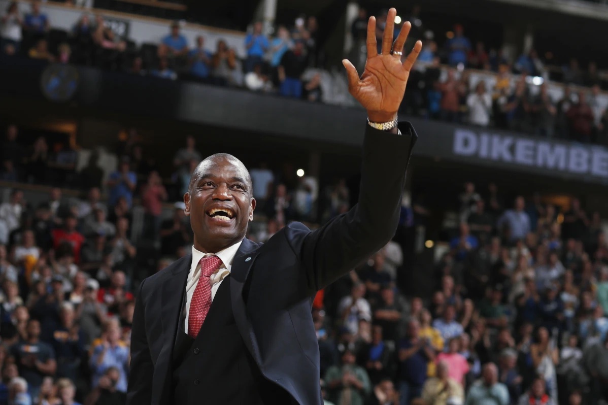 Retired Denver Nuggets center Dikembe Mutombo waves to the crowd as his jersey number was retired by the team during halftime of the Nuggets’ NBA basketball game against the Portland Trail Blazers on Saturday, Oct. 29, 2016, in Denver.