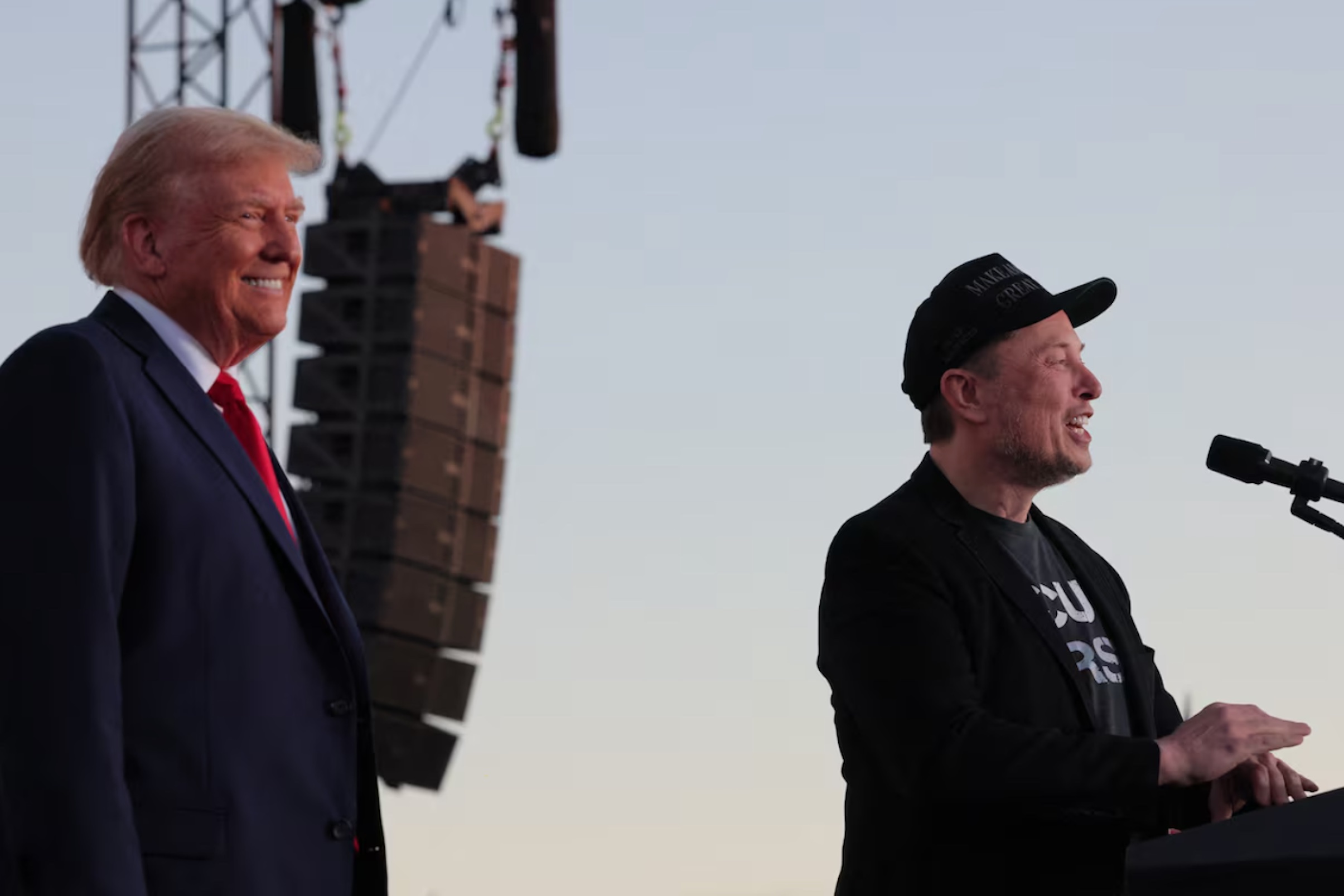 Tesla CEO and X owner Elon Musk speaks as Republican presidential nominee and former U.S. president Donald Trump looks on during a campaign rally, at the site of the July assassination attempt against Trump, in Butler, Pennsylvania, U.S., October 5, 2024.