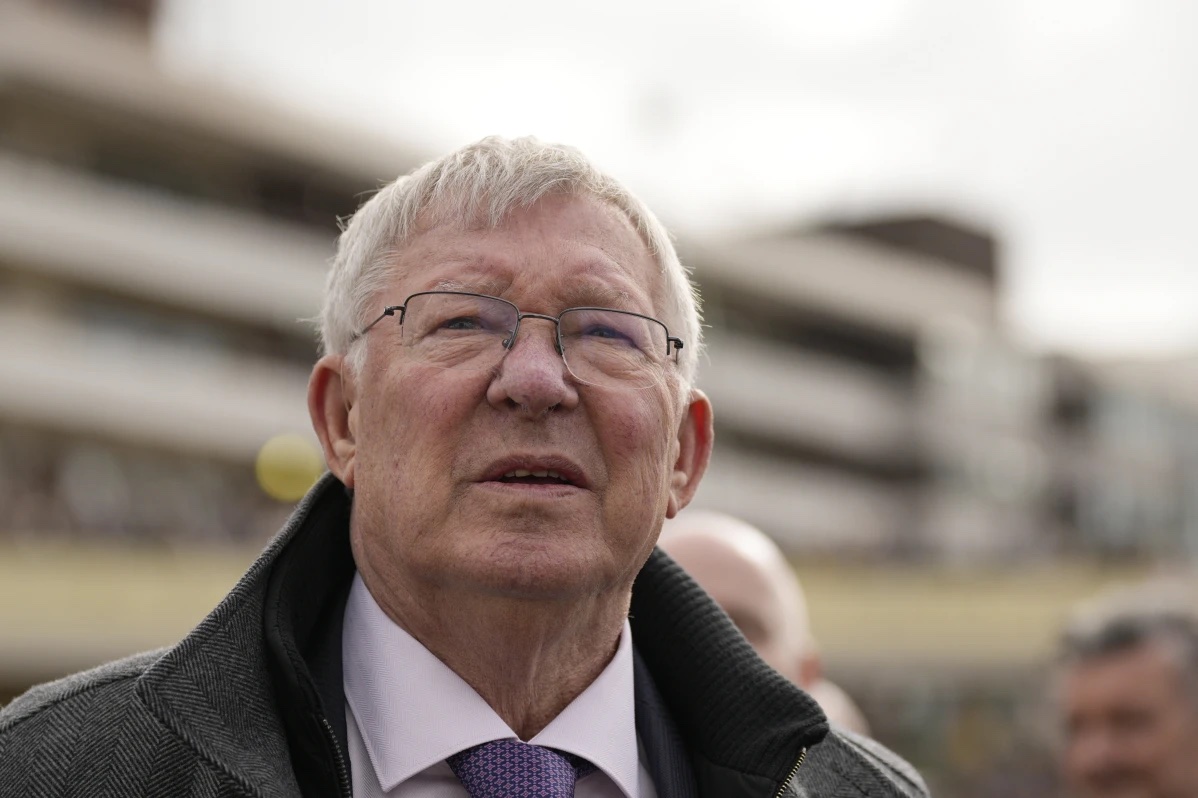 Former Manchester United manager Alex Ferguson, watches a large TV screen during The County Hurdle race as his horse L’Eau Du Sud came in second place behind Absurde, during the final day of the Cheltenham Festival at Cheltenham Racecourse, England, Friday, March 15, 2024.