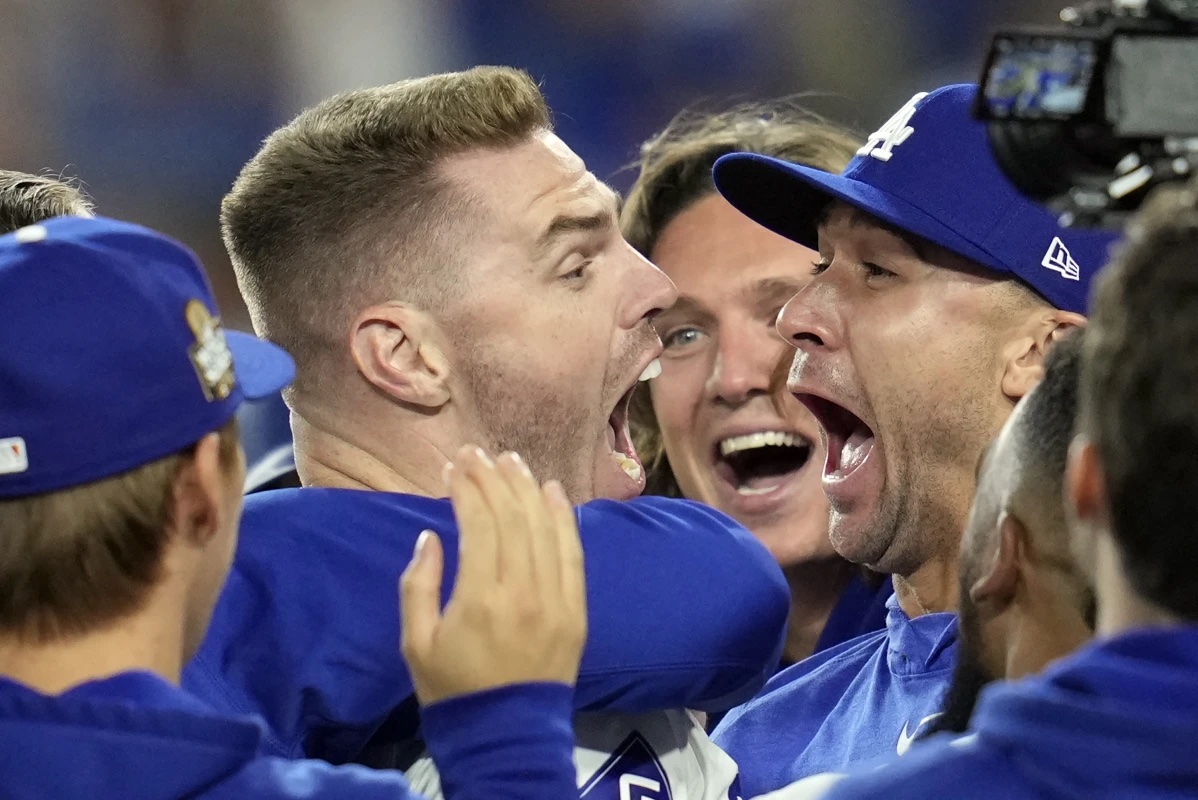 Los Angeles Dodgers’ Freddie Freeman, left, celebrates with starting pitcher Jack Flaherty, right, and teammates after hitting a walk-off grand slam against the New York Yankees during the 10th inning in Game 1 of the baseball World Series, Friday, Oct. 25, 2024, in Los Angeles. The Dodgers won 6-3.