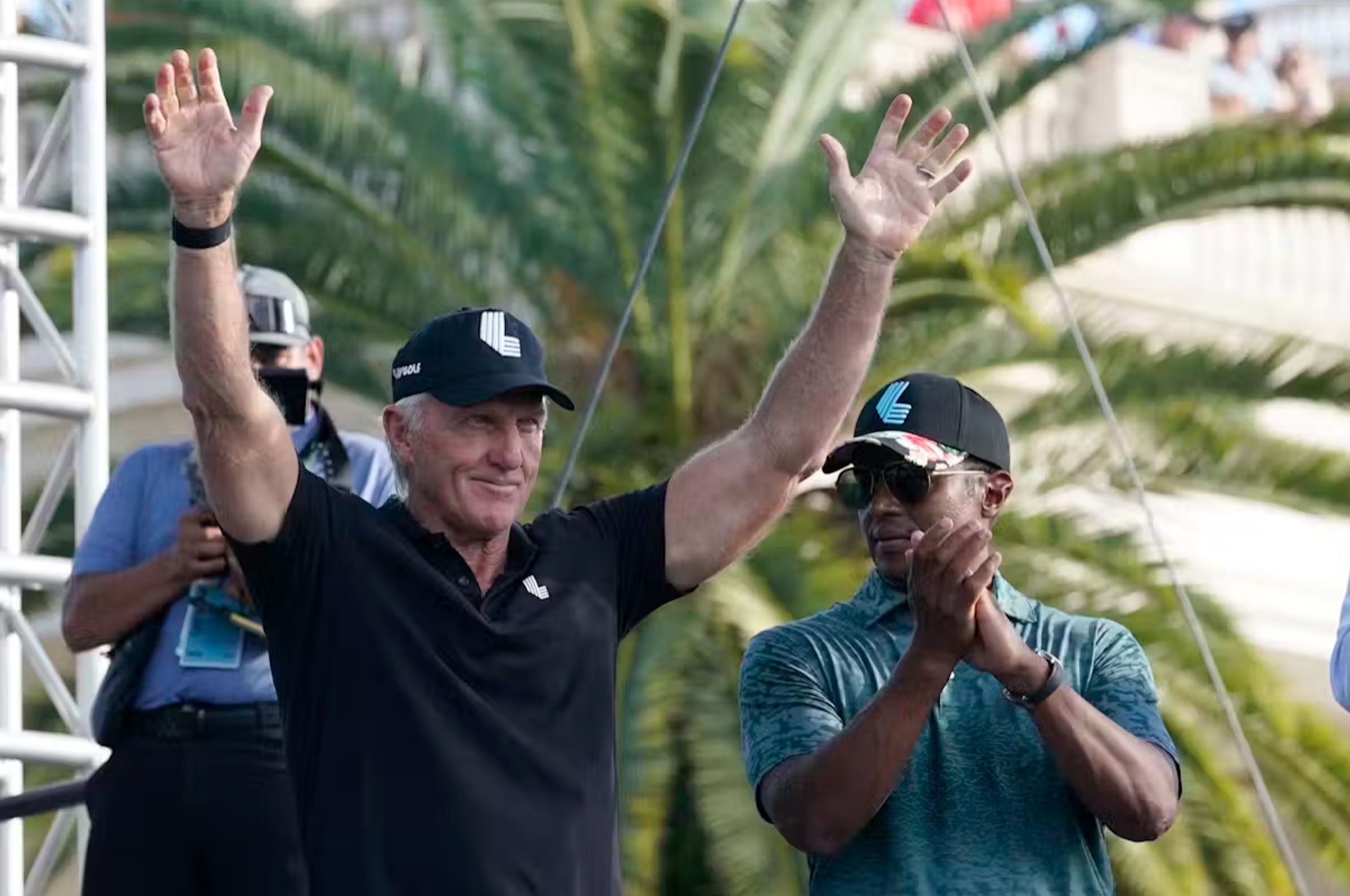 Majed Al-Sorour, CEO of Golf Saudi, right, and LIV Golf CEO Greg Norman, left, stand on the stage during a ceremony after the final round of the LIV Golf Team Championship in Doral, Fla., in October 2022.
