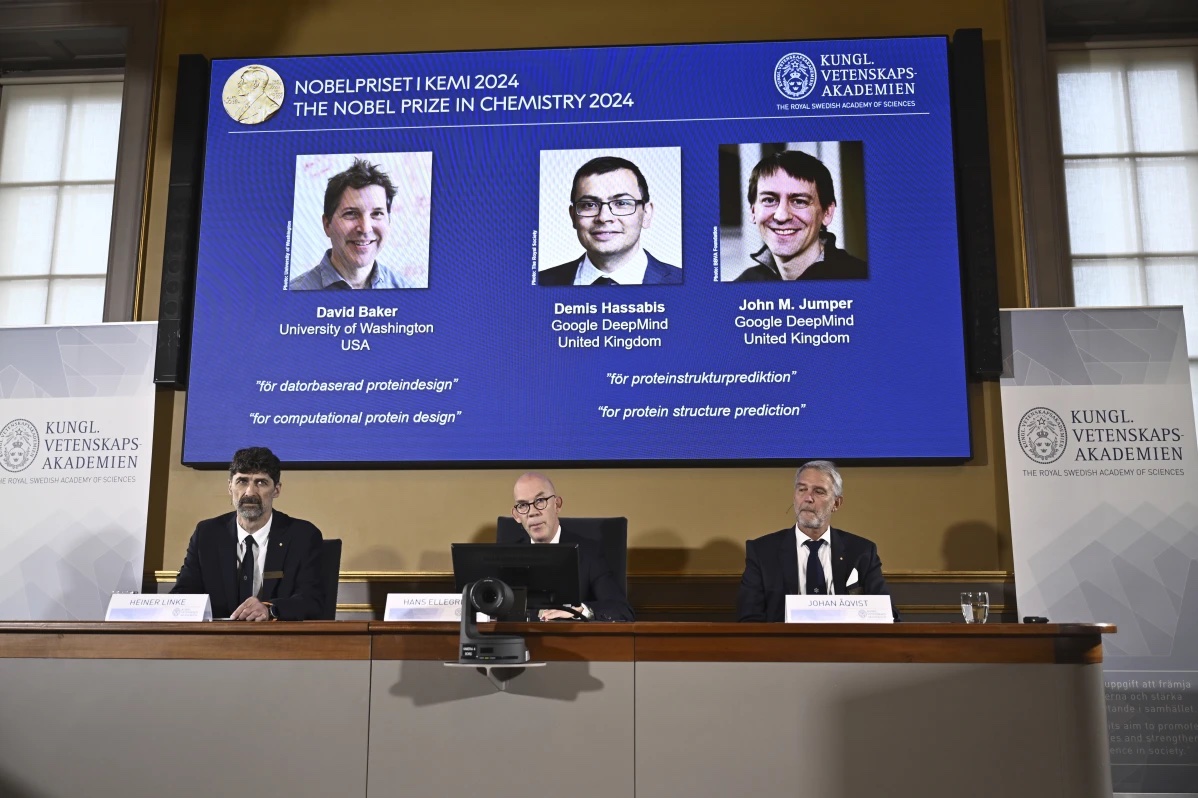 Johan Åqvist, member of the Nobel Committee for Chemistry, Hans Ellegren, Permanent Secretary and Heiner Linke, Chairman of the Nobel Committee for Chemistry award this years Nobel Prize in Chemistry to David Baker, Demis Hassabis, and John M Jumper at the Royal Swedish Academy of Sciences, in Stockholm, Sweden, Wednesday, Oct. 9, 2024.