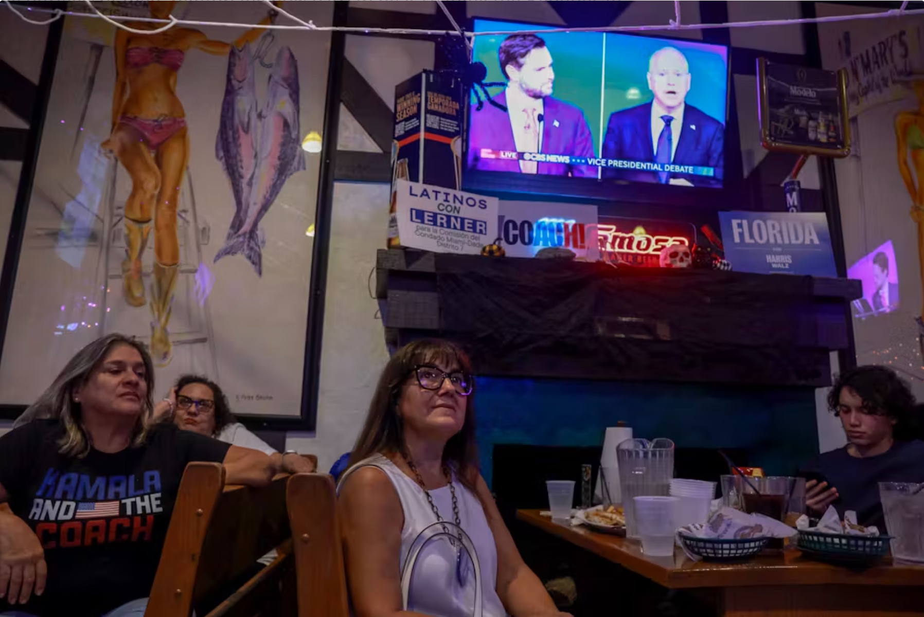 People watch the vice-presidential debate at the Miami-Dade Hispanic Caucus VP Debate Watch Party in Kendall, Fla.
