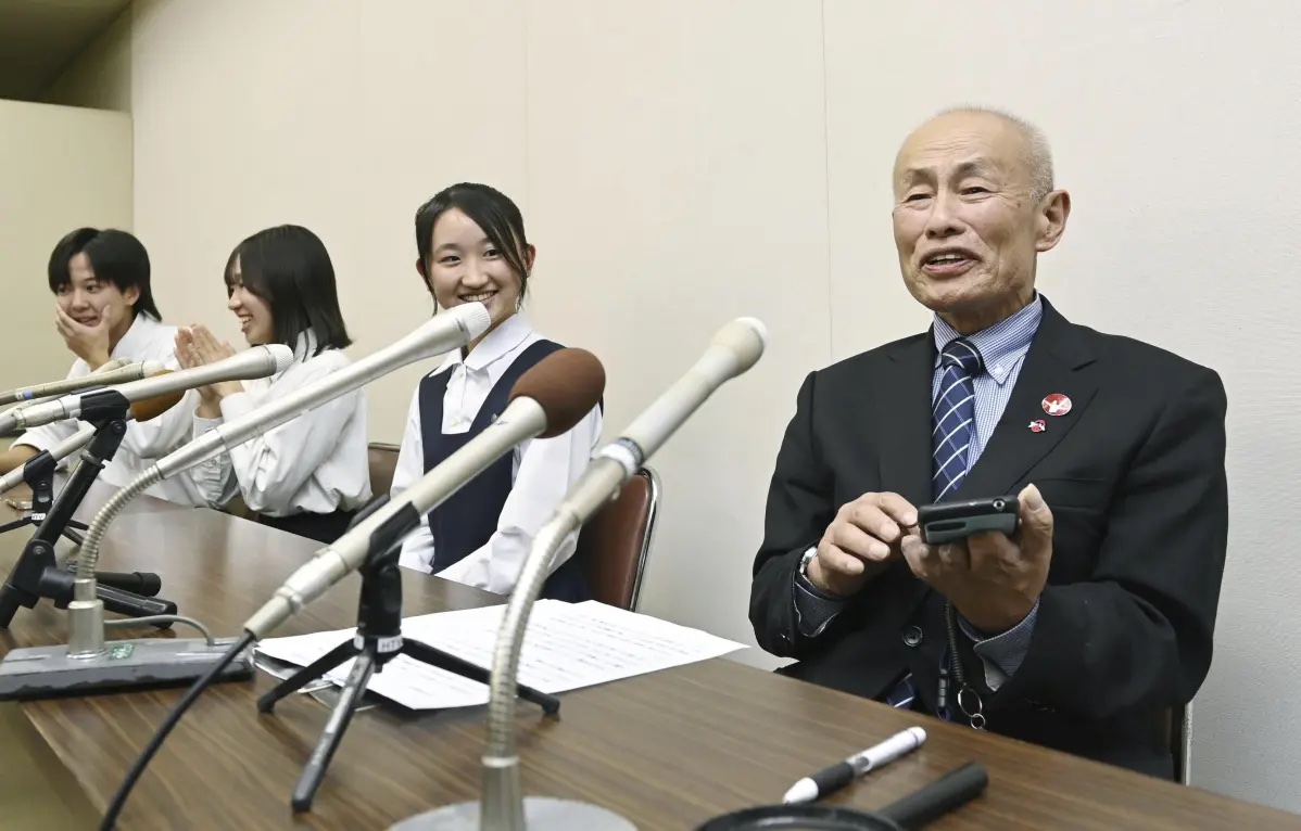 Toshiyuki Mimaki, right, president of Nihon Hidankyo, or the Japan Confederation of A- and H-Bomb Sufferers Organizations, speaks to media members in Hiroshima, Japan, Friday, Oct. 11, 2024, as he reacts to Ninon Hidankyo’s winning the Nobel Peace Prize.