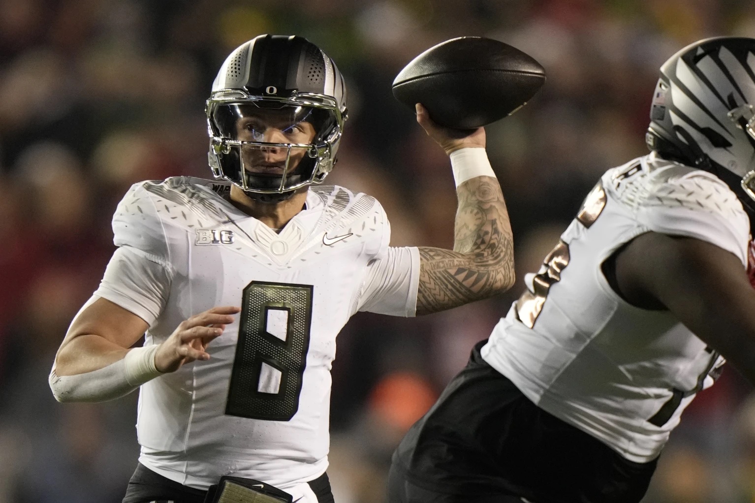 Oregon’s Dillon Gabriel (8) thorws a pass during the first half of an NCAA college football game against Wisconsin Saturday, Nov. 16, 2024, in Madison, Wis.