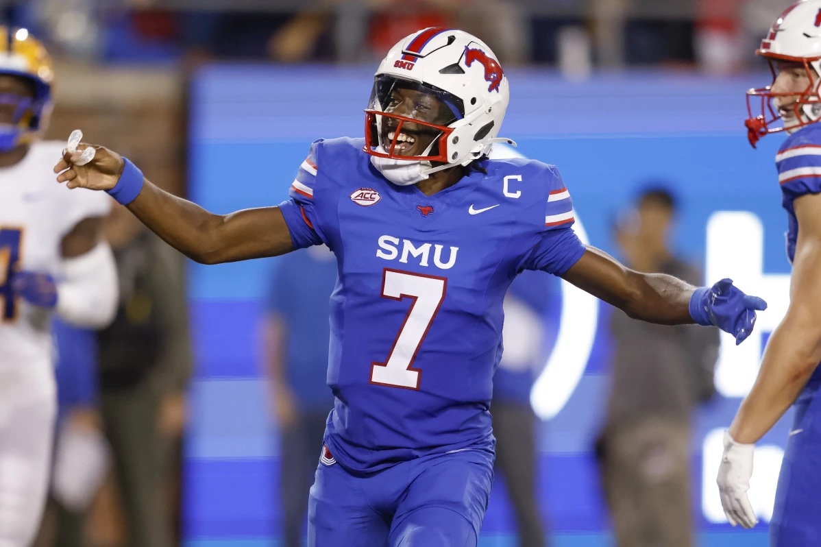 SMU quarterback Kevin Jennings (7) celebrates after throwing a touchdown pass during the first half of an NCAA college football game against Pittsburgh in Dallas, Saturday, Nov. 2, 2024.