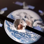 A satellite model is placed on a picture of Earth in this illustration taken November 25, 2024.