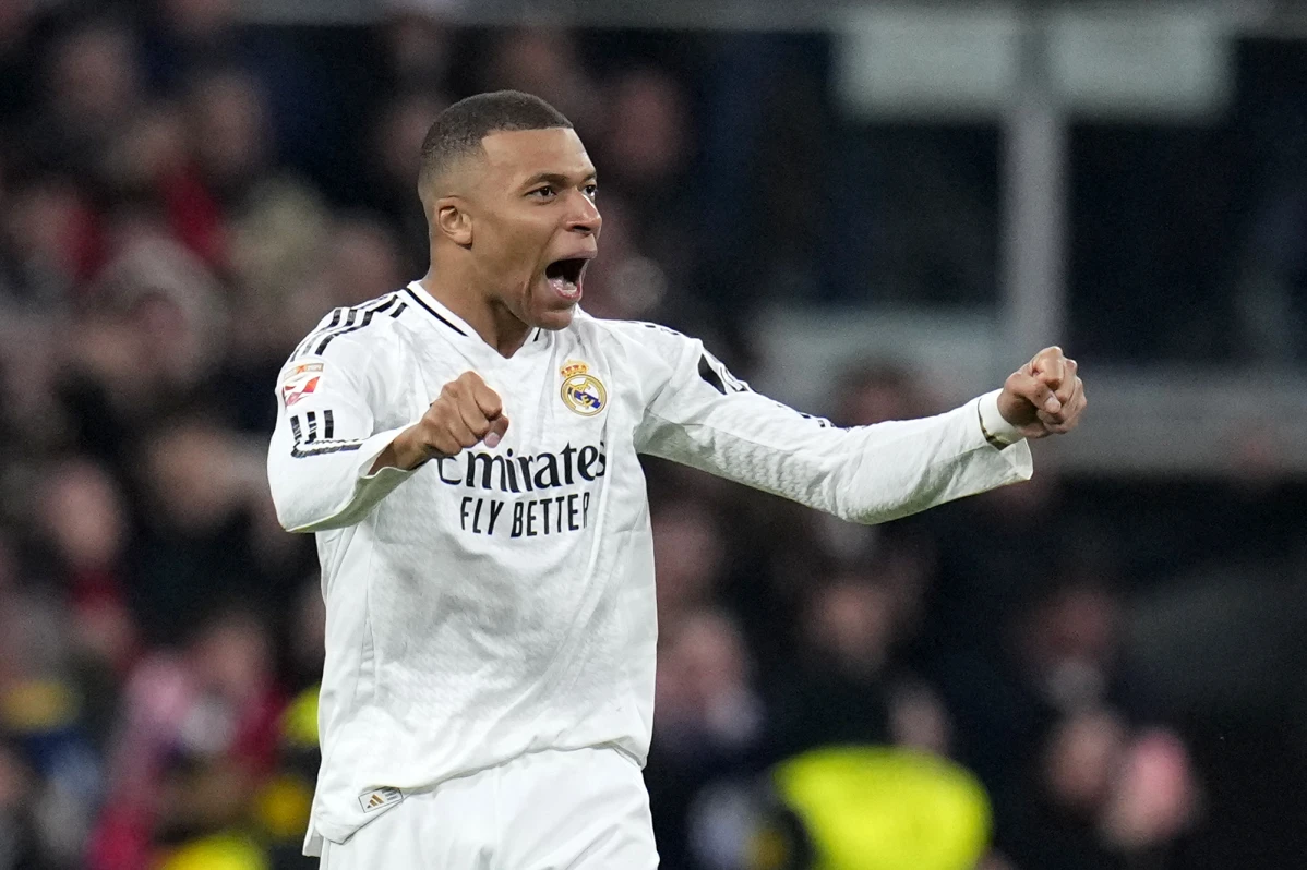 Real Madrid’s Kylian Mbappe celebrates after scoring his side’s first goal during a Spanish La Liga soccer match between Real Madrid and Atletico Madrid at the Santiago Bernabeu stadium in Madrid, Saturday, Feb. 8, 2025.