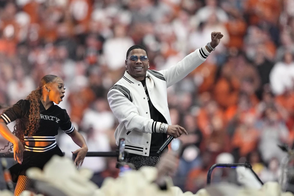 Entertainer Nelly performs at halftime of the Big 12 Conference championship NCAA college football game between Oklahoma State and Texas in Arlington, Texas, Saturday, Dec. 2, 2023.