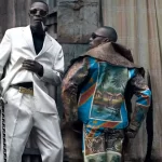 Papa Griffe (L), a senior and a leader of the sapeurs, poses for pictures with his brother Jika.