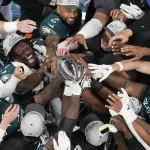 Philadelphia Eagles players celebrate with the Vince Lombardi Trophy after the Eagles won the NFL Super Bowl 59 football game against the Kansas City Chiefs, Sunday, Feb. 9, 2025, in New Orleans.