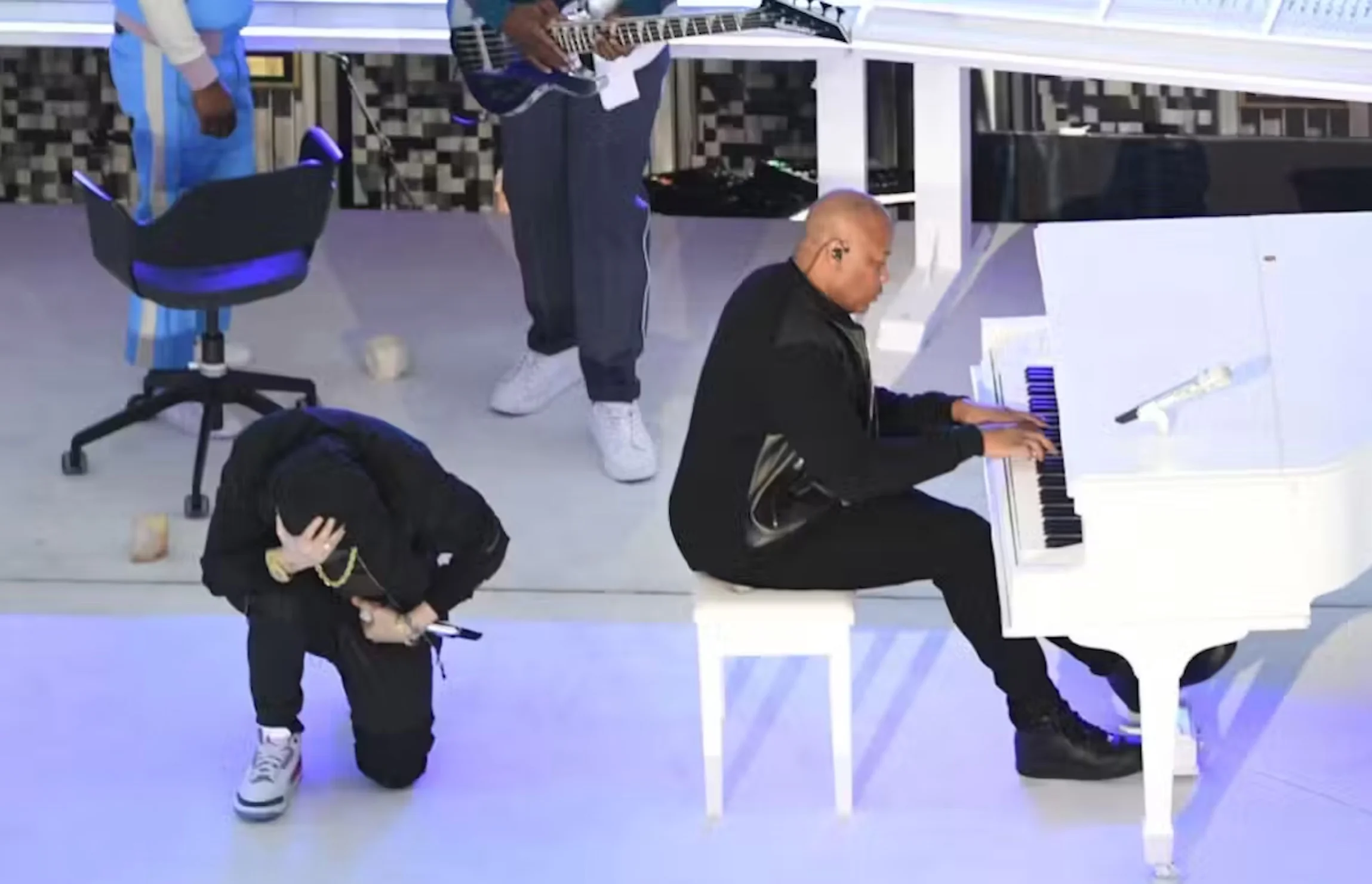 Rapper Eminem takes a knee as he performs during the halftime show of Super Bowl 56 on Feb. 13, 2022.