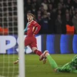 Liverpool’s Harvey Elliott scores the opening goal past PSG’s goalkeeper Gianluigi Donnarumma during the Champions League round of 16 first leg soccer match between Paris Saint-Germain and Liverpool at the Parc des Princes in Paris, Wednesday, March 5, 2025.