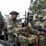 M23 rebels sit on a truck during the escort of captured FDLR members (not pictured) to Rwanda for repatriation, at the Goma-Gisenyi Grande Barrier border crossing, March 1, 2025.