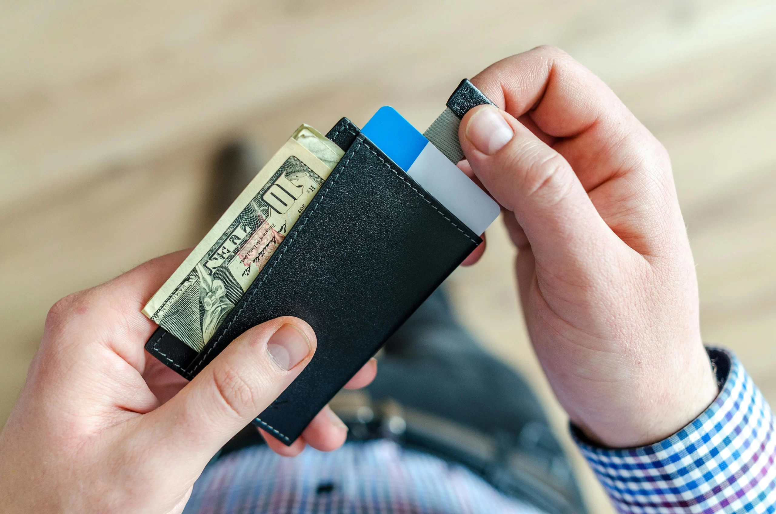 A Person holding black card holder.