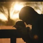 A man carrying baby.