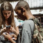 Young tourists checking their smartphones