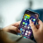 Woman holding iphone applications.