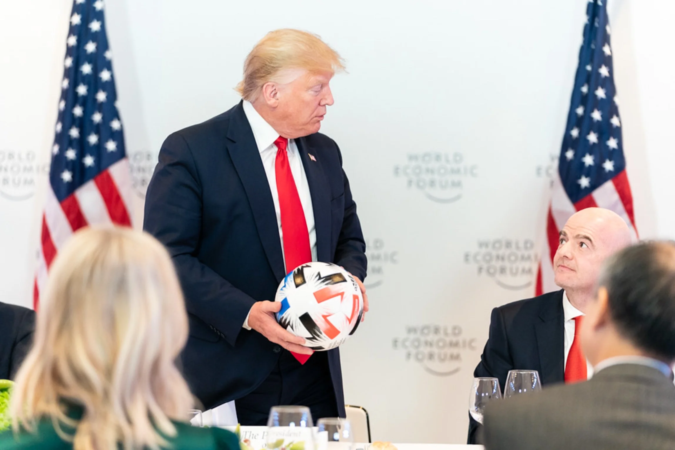 President Donald J. Trump accepts a soccer ball from FIFA President Gianni Infantino at a dinner with Global Chief Executive Officers Tuesday, Jan. 21, 2020, at the Davos Congress Centre in Davos, Switzerland.