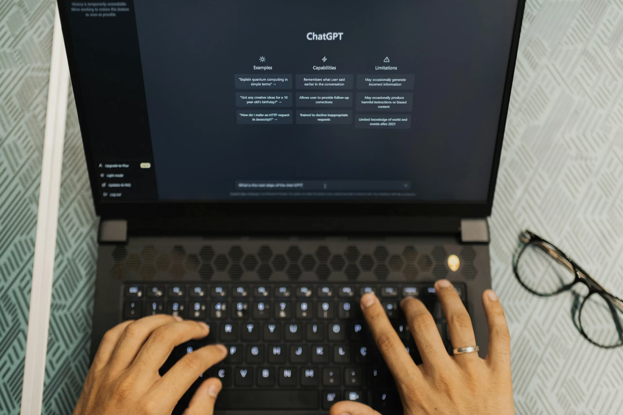A man using a laptop with Chatgpt’s Webpage displayed.