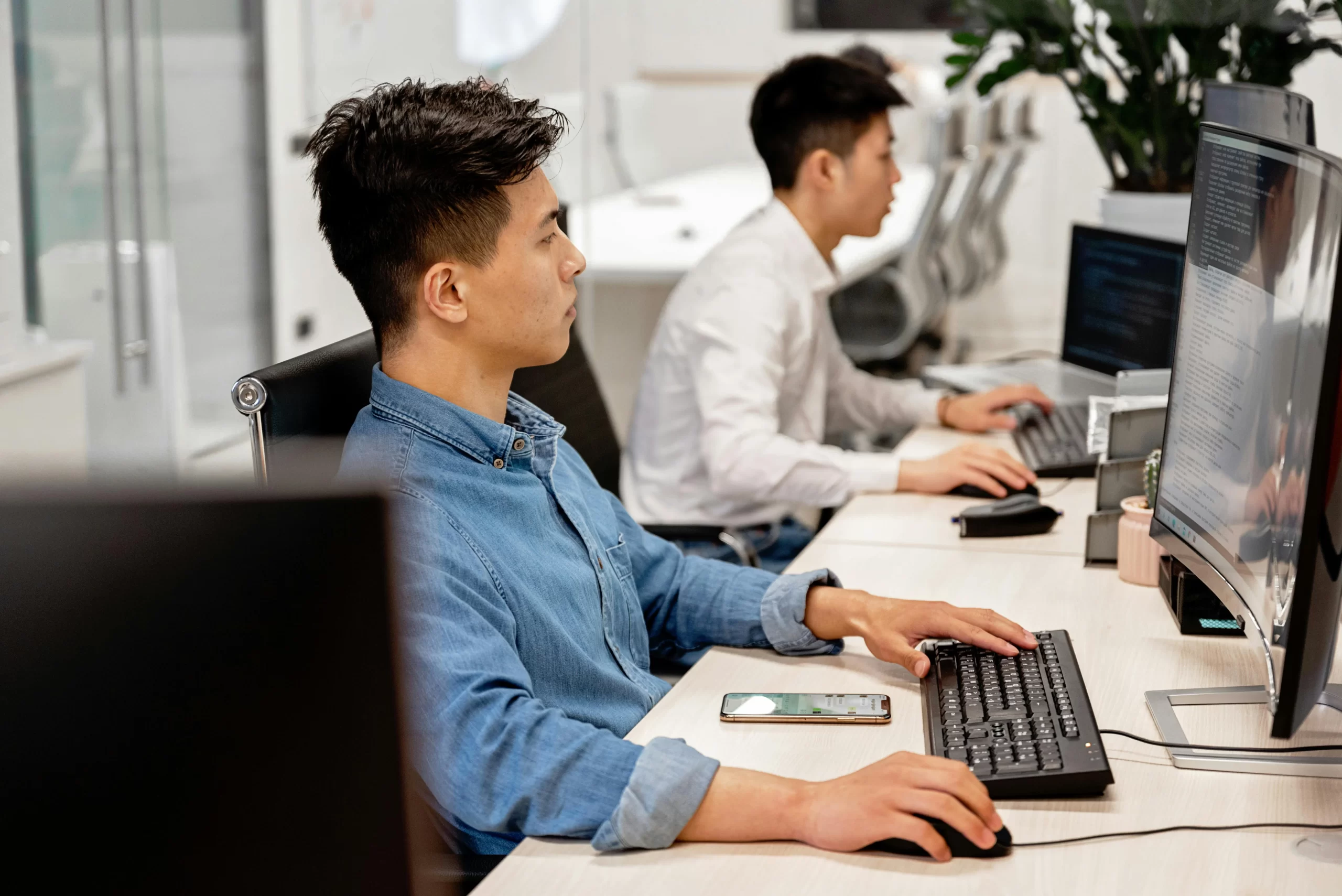 Men sitting in front of the computer.