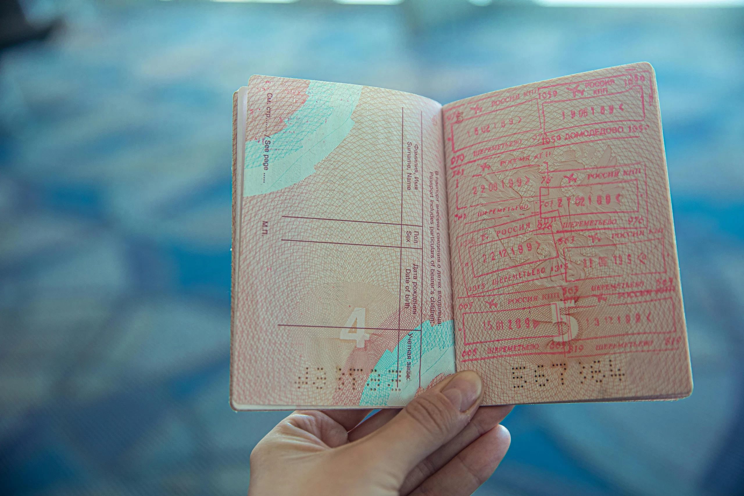 Person Holding an Opened Passport.