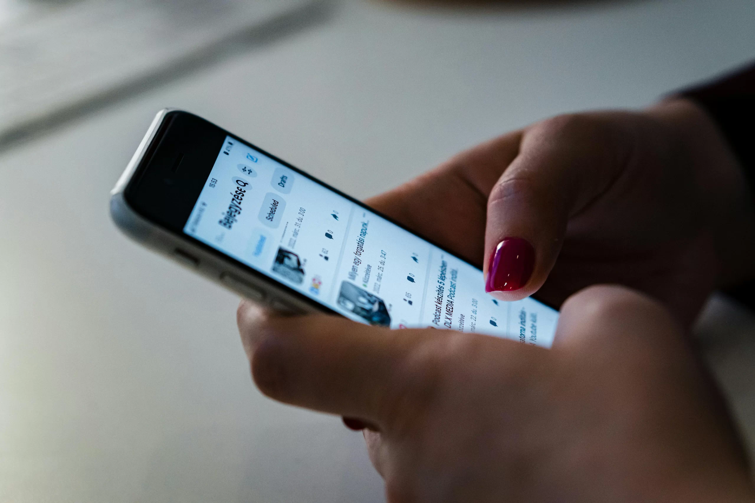 A person using a cellphone checking social media.