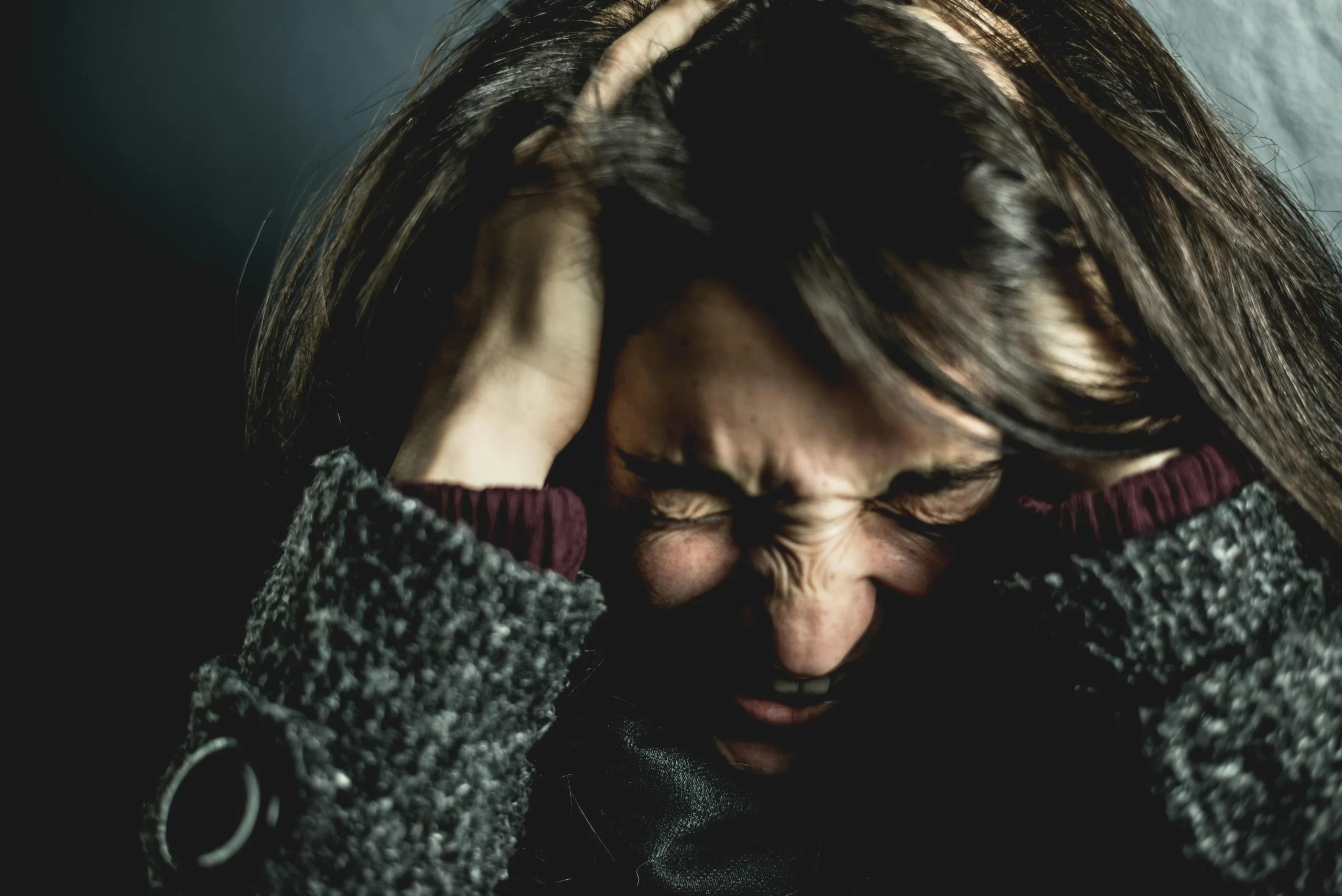 A woman holding her head.