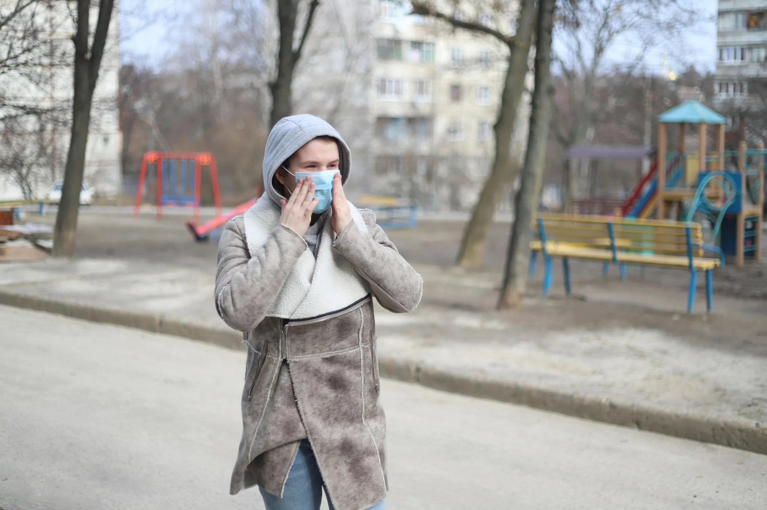 Woman wearing face mask in freezing temperature.